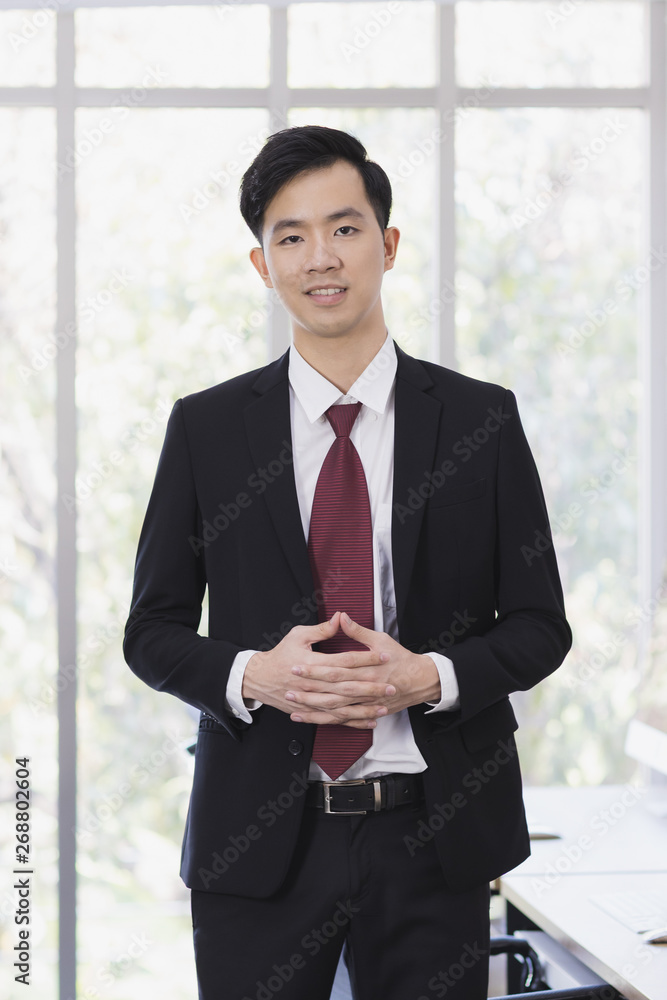 Asian Businessman standing and posing in office.. Asian Businessman standing and posing in office..