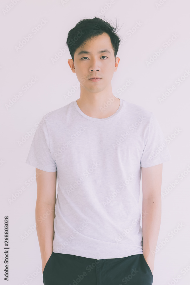Young Asian man model in T-shirt standing.. Young Asian man model in T-shirt standing..
