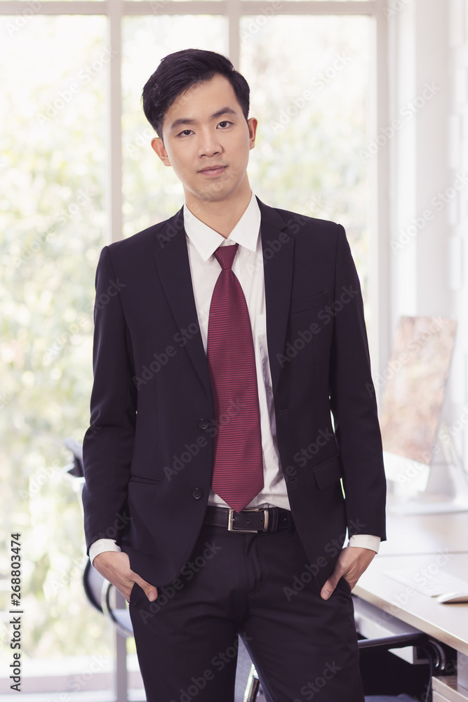 Asian Businessman standing and posing in office..