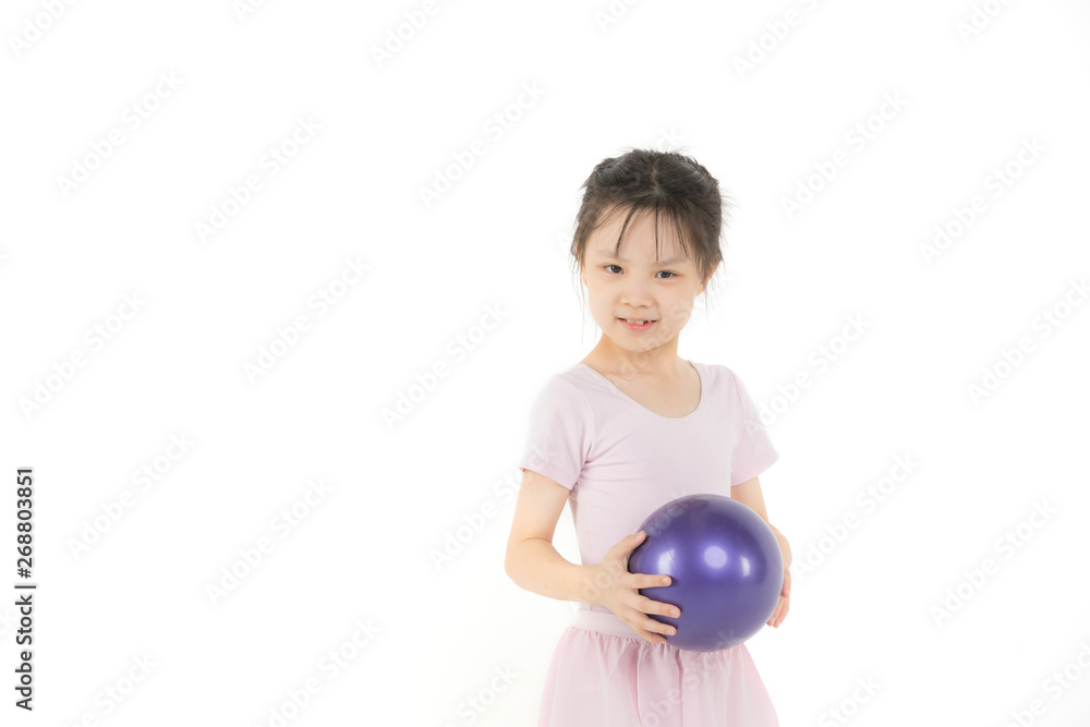 Asian girl in pink dress is holding ball.. Asian girl in pink dress is holding ball..