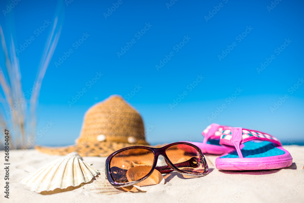 Summer beach accessories on sand, tourism, vacation and seaside recreation concept