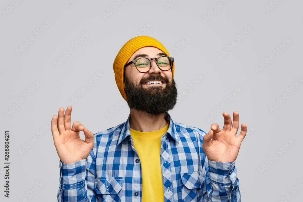 Naklejka premium Glad hipster gesturing OK