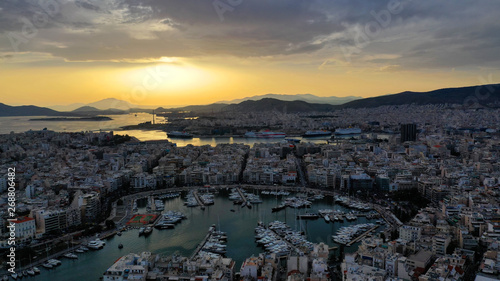 Aerial drone bird's eye view of famous port of Piraeus one of the largest in Europe at sunset with beautiful golden colours, Attica, Greece © aerial-drone