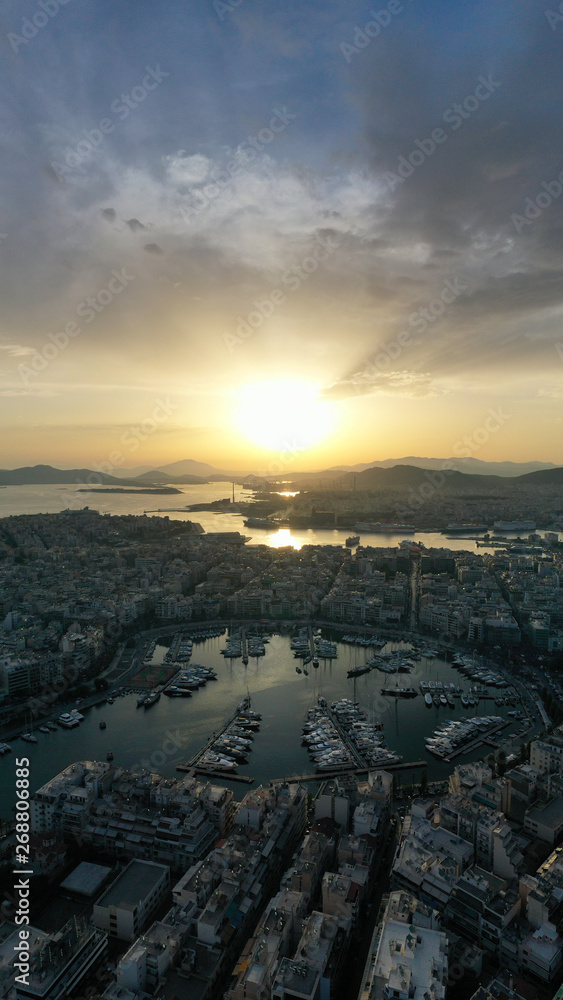 Obraz premium Aerial drone bird's eye view of famous port of Piraeus one of the largest in Europe at sunset with beautiful golden colours, Attica, Greece