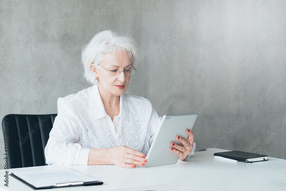 Confident business lady with tablet. Digital analysis. Company performance. Competent financial management. Great sales. Confident business lady with tablet. Digital analysis. Company performance. Competent financial management. Great sales.