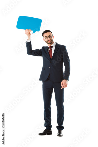 smiling businessman in black suit holding speech bubble above head isolated on white © LIGHTFIELD STUDIOS