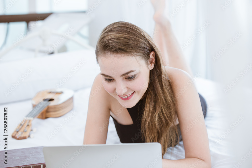 women working at home using laptop computer for work on the bed happy enjot smile women working at home using laptop computer for work on the bed happy enjot smile