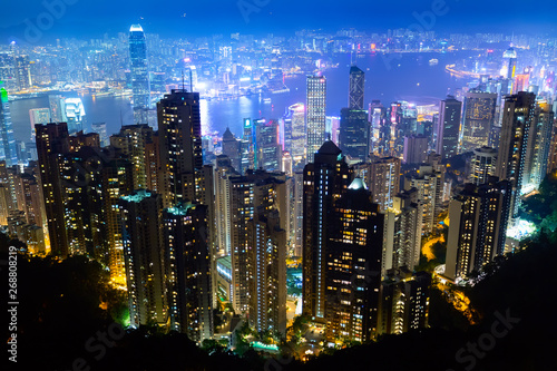 The most famous view of Hong Kong at twilight sunset. Hong Kong skyscrapers skyline cityscape view from Victoria Peak illuminated in the evening. Hong Kong, special administrative region in China. © Nikolay N. Antonov