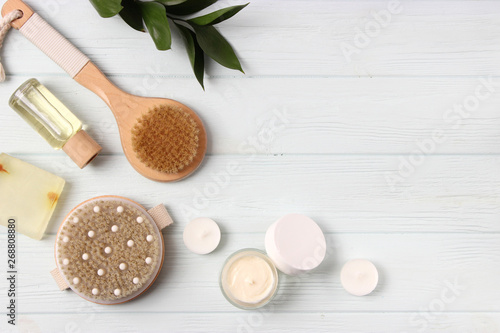 Brush for massage in the spa composition on a colored background top view. Prevention of cellulite skin care. Flatlay