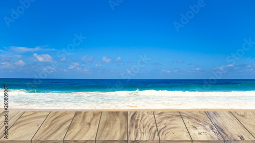 Top view wood table perspective on beach sea background © BUDDEE