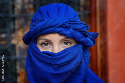 Portrait of woman wearing blue tuareg scarf photo