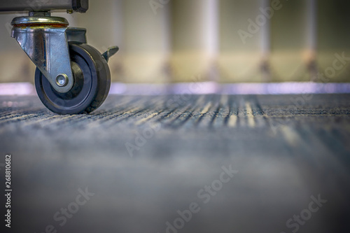 Small black rubber wheels on the carpet.