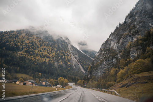 Asphalt mountain road in austrian alps in rainy day © glebcallfives