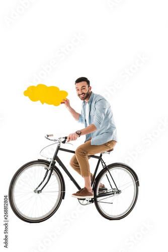 cheerful man riding bicycle while holding thought bubble isolated on white