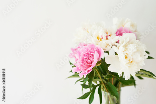 peonies in a vase on a white background