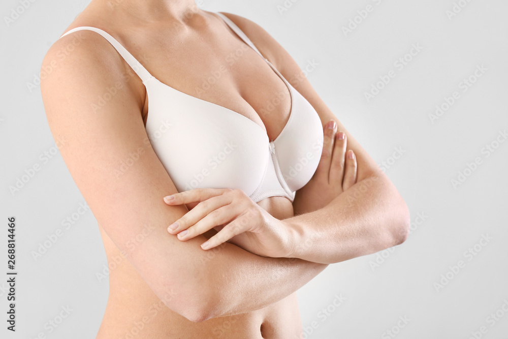 Young woman with beautiful breast on white background
