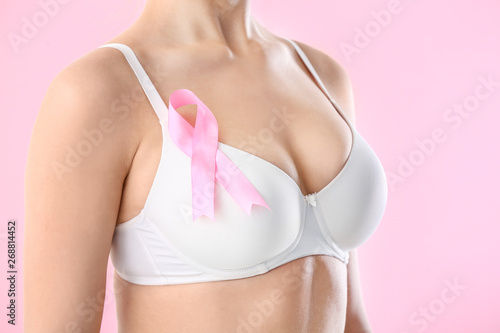 Young woman with pink ribbo...