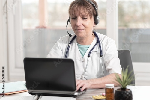 Portrait of female doctor during online medical consultation