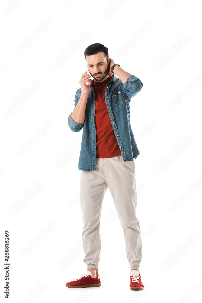thoughtful bearded man in denim shirt using smartphone isolated on white thoughtful bearded man in denim shirt using smartphone isolated on white