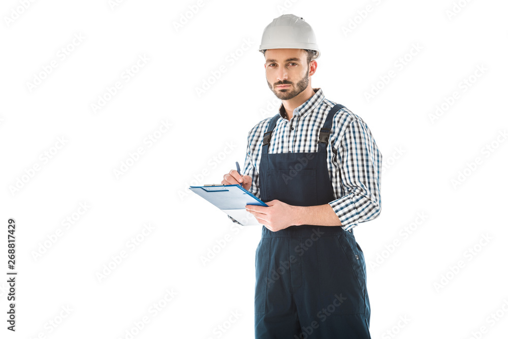 serious bearded construction worker writing on clipboard and looking at camera isolated on white serious bearded construction worker writing on clipboard and looking at camera isolated on white