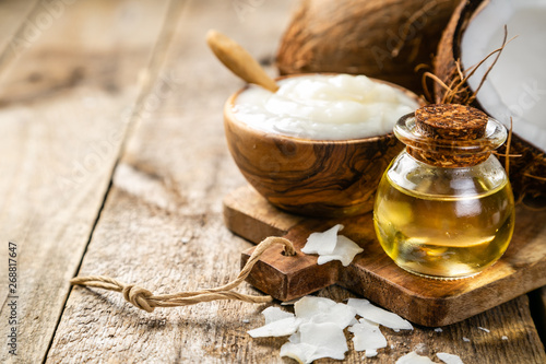 Valokuva MCT coconut oil concept - coconuts, butter and oil on wood background, copy spac