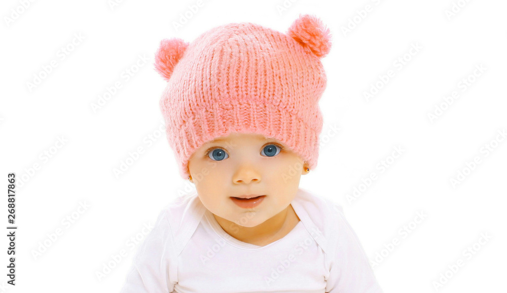 Portrait close-up happy smiling baby in knitted pink hat on white background Portrait close-up happy smiling baby in knitted pink hat on white background