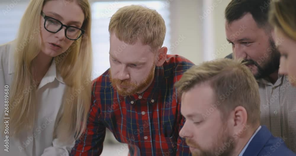 Group of young businesspeople working in a modern office Group of young businesspeople working in a modern office