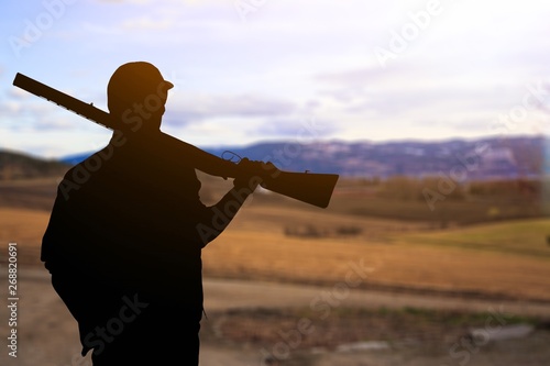 Male Hunter with Rifle on natural background