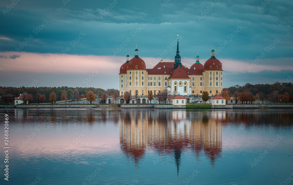 Wonderful picturesque Scene with Dramatic Colorful sky. Incredible View of Moritzburg Castle near Dresden, Saxony, Germany  reflected in the water, during autumn morning. Instagram filter