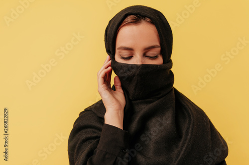 Canvas Print Studio frame of young charming arabian lady  wearing yashmak looking down over i