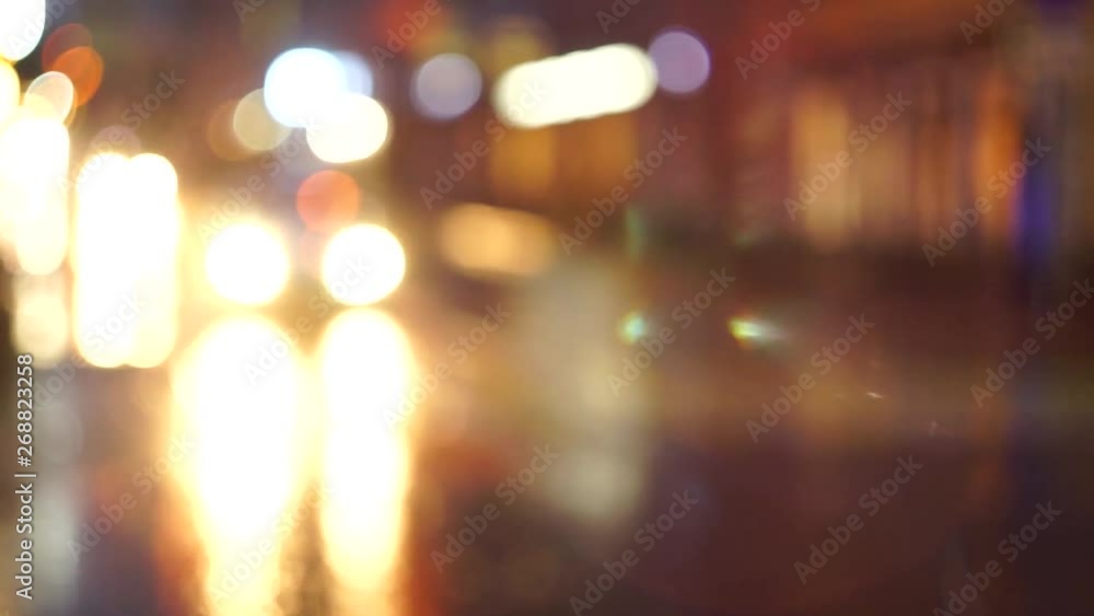 Lights of a big city, reflection with blur on wet asphalt, light spots from car headlights. Night, rainy weather. Lights of a big city, reflection with blur on wet asphalt, light spots from car headlights. Night, rainy weather.