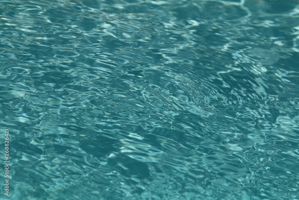 Close up of clean sparkling turquoise swimming pool water, showing good pool maintenance.owing Close up of clean sparkling turquoise swimming pool water, showing good pool maintenance.owing