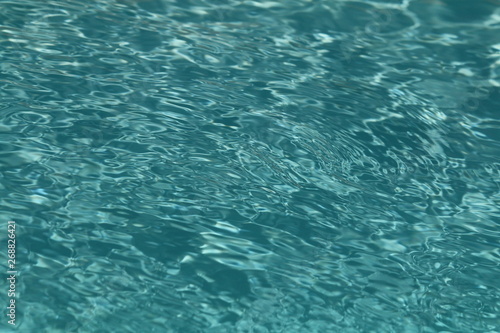Close up of clean sparkling turquoise swimming pool water, showing good pool maintenance.owing