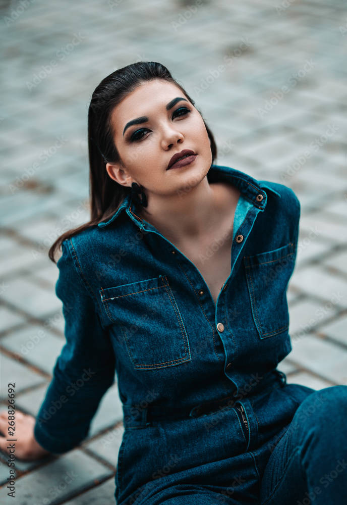 close up portrait of beautiful sexy young woman, in jeans costume and dark make up smoky eyes