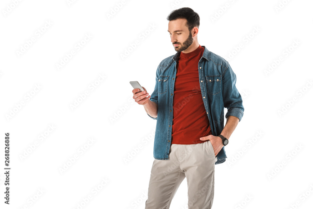 pensive man using smartphone while standing with hand in pocket isolated on white pensive man using smartphone while standing with hand in pocket isolated on white