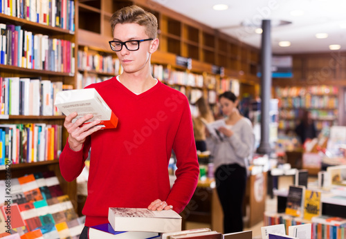  guy with stack of books in hands
