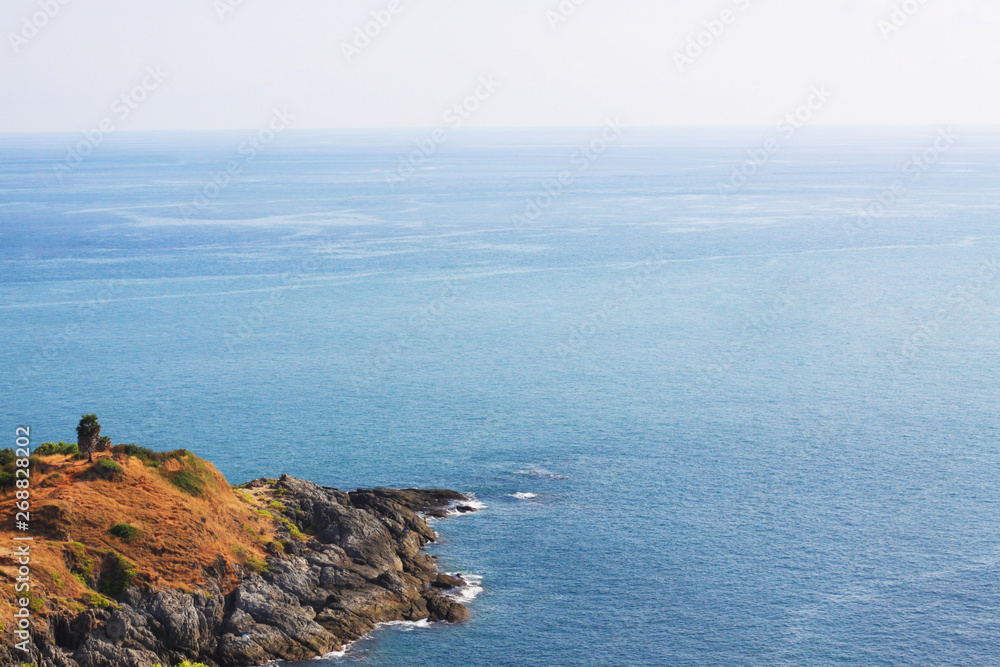 Beautiful seascape with sky twilight of sunset and sea horizon with Calm and blue sky.Dry grass field on mountain of Phrom Thep Cape is famous place in Phuket island, Thailand. Beautiful seascape with sky twilight of sunset and sea horizon with Calm and blue sky.Dry grass field on mountain of Phrom Thep Cape is famous place in Phuket island, Thailand.