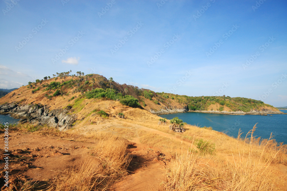 Beautiful seascape with sky twilight of sunset and sea horizon with Calm and blue sky.Dry grass field on mountain of Phrom Thep Cape is famous place in Phuket island, Thailand. Beautiful seascape with sky twilight of sunset and sea horizon with Calm and blue sky.Dry grass field on mountain of Phrom Thep Cape is famous place in Phuket island, Thailand.