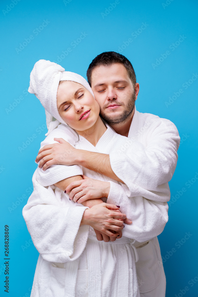 Photo of young woman and man in bathrobe hugging themselves Photo of young woman and man in bathrobe hugging themselves
