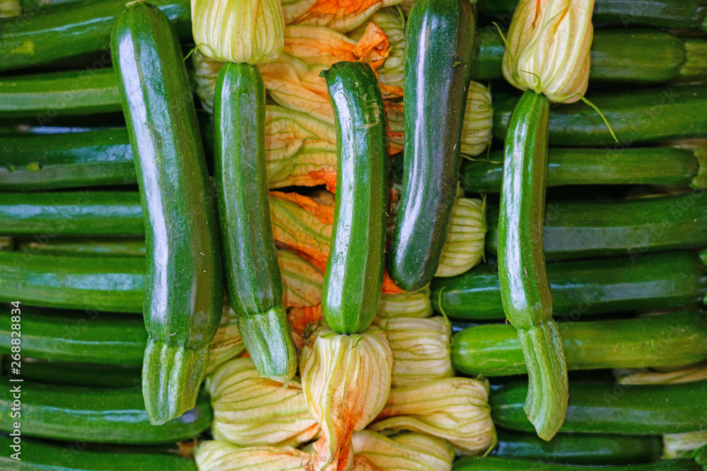 Zucchini flower blossoms in a crate at an Italian farmers market