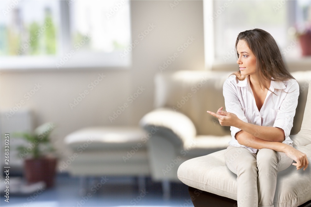 Portrait of a young pretty woman sitting isolated on background Portrait of a young pretty woman sitting isolated on background