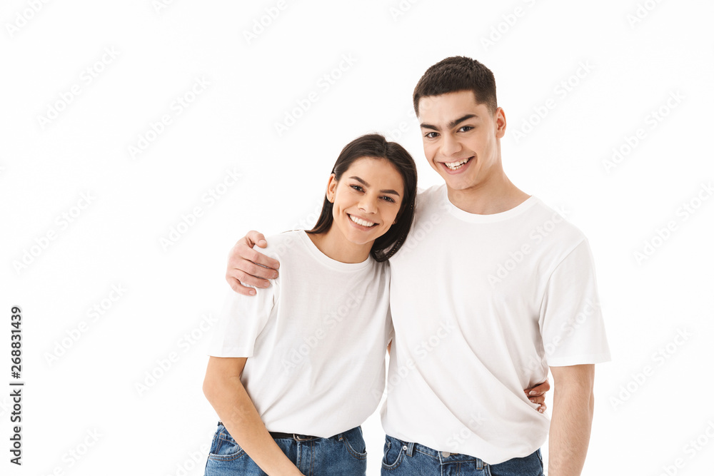 Attractive young couple standing isolated over white Attractive young couple standing isolated over white