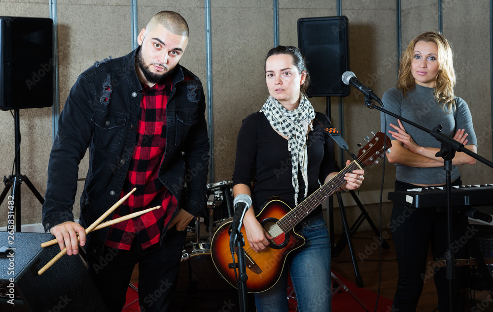Fototapeta premium group of rock musicians posing with instruments