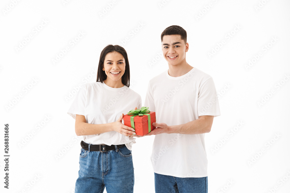 Attractive young couple standing isolated over white Attractive young couple standing isolated over white