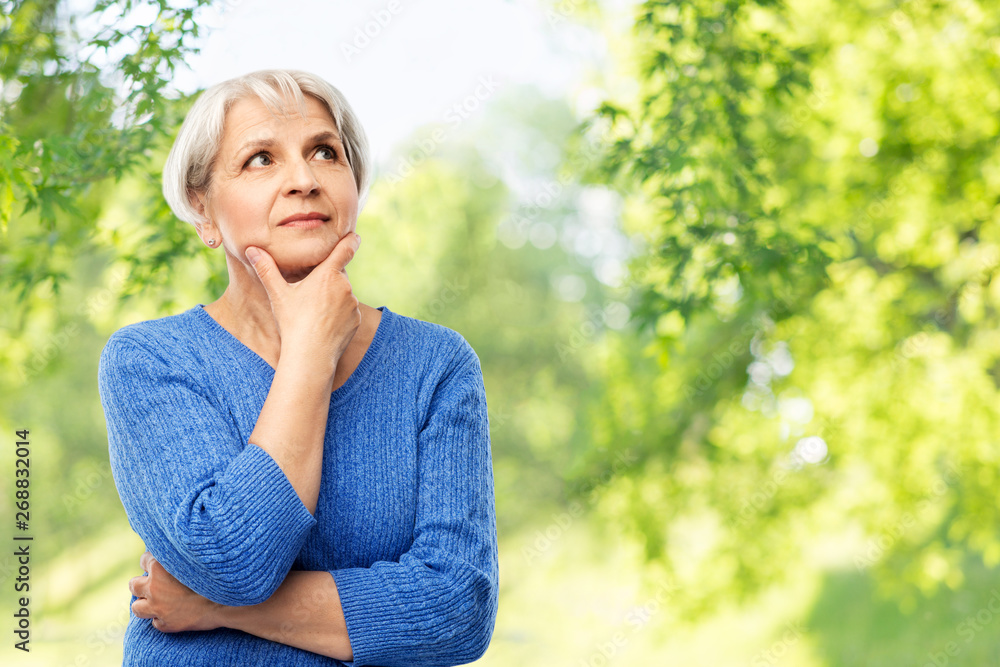 old people and decision making concept - portrait of senior woman in blue sweater thinking over grey background old people and decision making concept - portrait of senior woman in blue sweater thinking over grey background