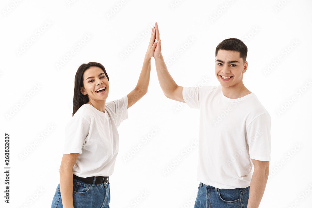 Attractive young couple standing isolated over white Attractive young couple standing isolated over white
