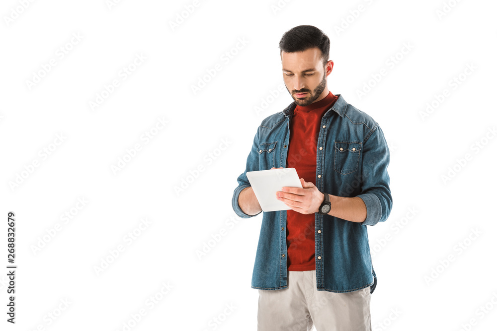 thoughtful bearded man in denim shirt using digital tablet isolated on white thoughtful bearded man in denim shirt using digital tablet isolated on white