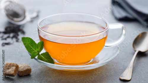 Tea cup with mint leaf. Grey background. Close up.