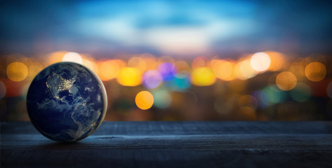 Planet Earth on the background of blurred lights of the city. Concept on business, politics, ecology and media. Earth day abstract background. Elements of this image furnished by NASA