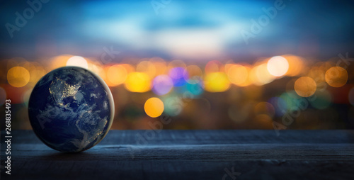 Planet Earth on the background of blurred lights of the city. Concept on business  politics  ecology and media. Earth day abstract background. Elements of this image furnished by NASA